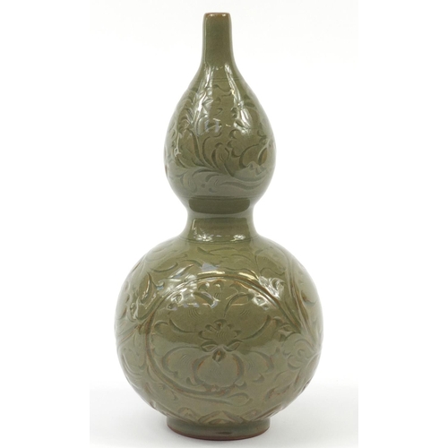 515 - Korean stoneware double gourd vase having a celadon glaze, incised with floral motifs, 33.5cm high