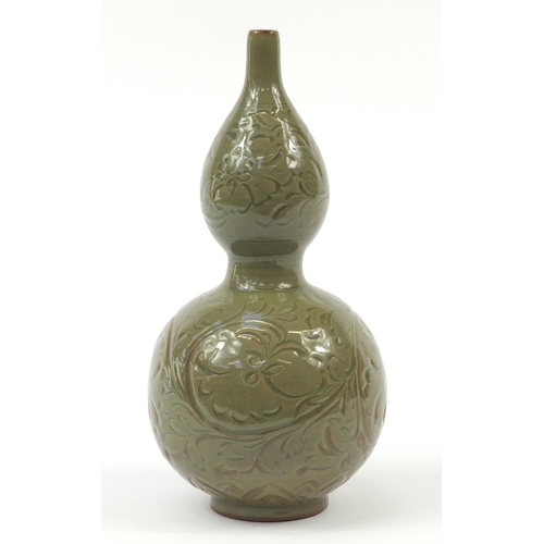 515 - Korean stoneware double gourd vase having a celadon glaze, incised with floral motifs, 33.5cm high