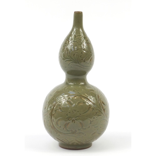 515 - Korean stoneware double gourd vase having a celadon glaze, incised with floral motifs, 33.5cm high