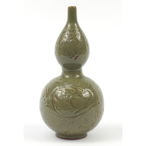 515 - Korean stoneware double gourd vase having a celadon glaze, incised with floral motifs, 33.5cm high