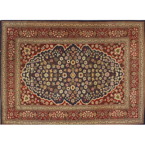 1528A - Rectangular Persian Hereke design rug decorated with stylised flowers onto midnight blue and red gro... 