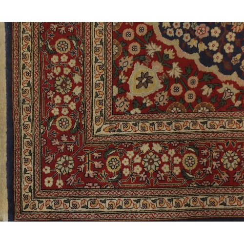 1528A - Rectangular Persian Hereke design rug decorated with stylised flowers onto midnight blue and red gro... 