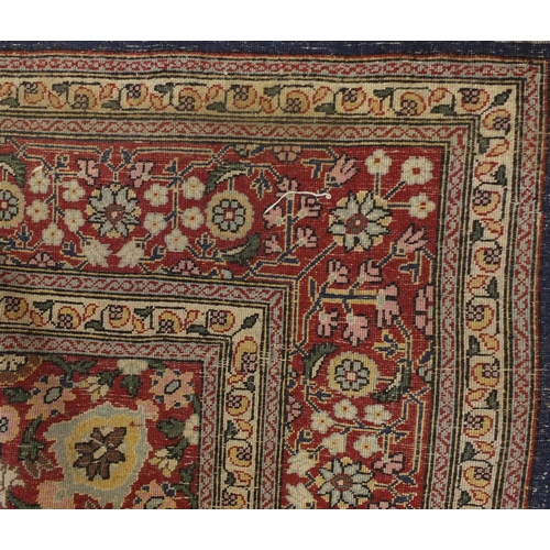 1528A - Rectangular Persian Hereke design rug decorated with stylised flowers onto midnight blue and red gro... 