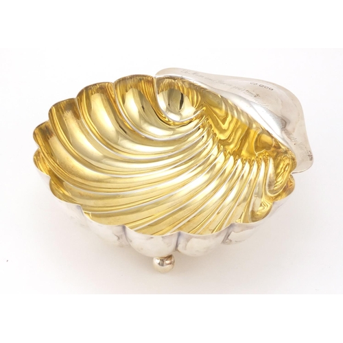 3051 - Atkin Brothers, Edward VII large silver shell shaped bowl with gilt interior, raised on three ball f... 