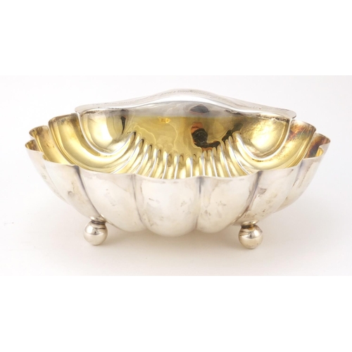 3051 - Atkin Brothers, Edward VII large silver shell shaped bowl with gilt interior, raised on three ball f... 