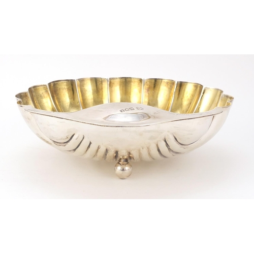 3051 - Atkin Brothers, Edward VII large silver shell shaped bowl with gilt interior, raised on three ball f... 