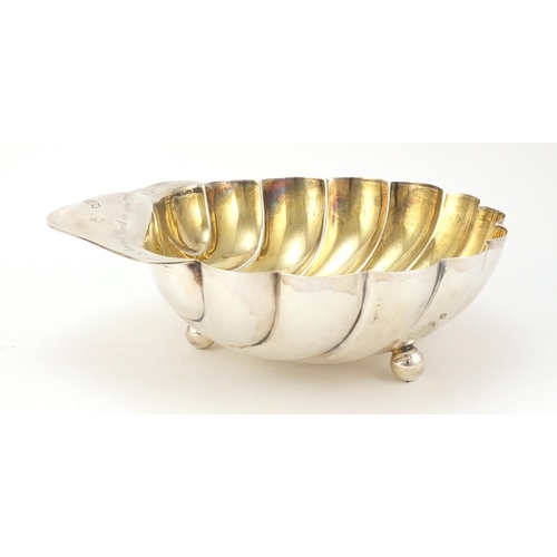 3051 - Atkin Brothers, Edward VII large silver shell shaped bowl with gilt interior, raised on three ball f... 