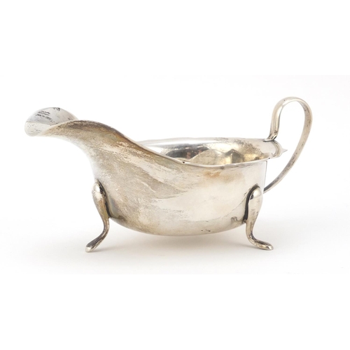 3064 - Viner's Ltd, George V silver sauce boat, raised on three feet, Sheffield 1932, 15cm wide, 131.5g