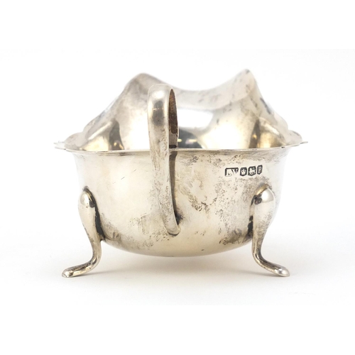 3064 - Viner's Ltd, George V silver sauce boat, raised on three feet, Sheffield 1932, 15cm wide, 131.5g