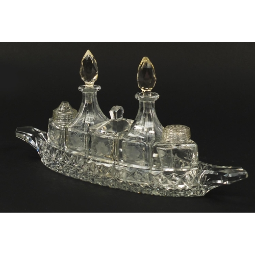 103 - Cut glass boat cruet stand with bottles, 31cm wide