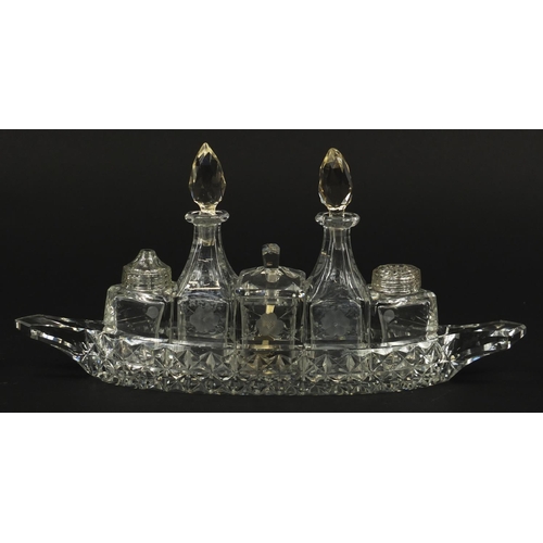 103 - Cut glass boat cruet stand with bottles, 31cm wide