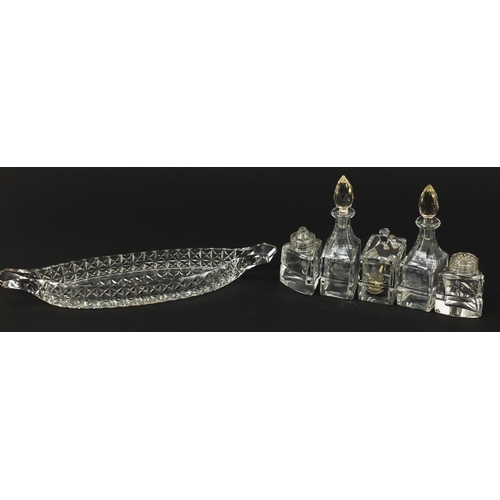 103 - Cut glass boat cruet stand with bottles, 31cm wide