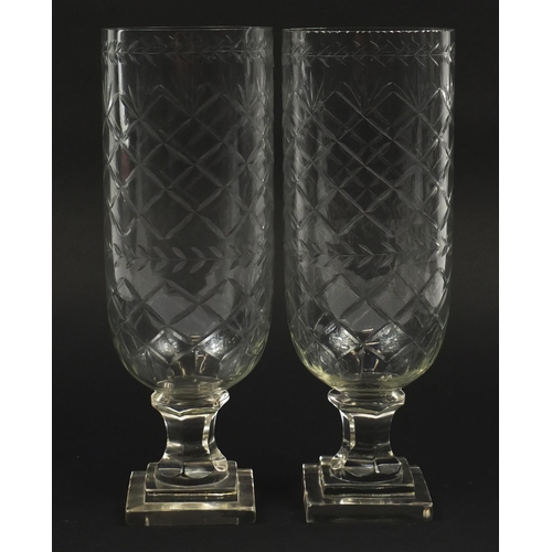 102 - Pair of Georgian design cut glass celery vases raised on stepped square bases, each 34cm high