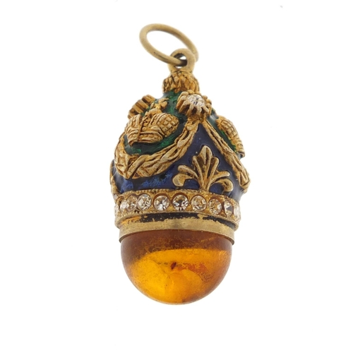 2351 - Russian unmarked silver gilt enamel and amber egg pendant, 3cm in length, 8.0g