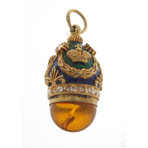 2351 - Russian unmarked silver gilt enamel and amber egg pendant, 3cm in length, 8.0g