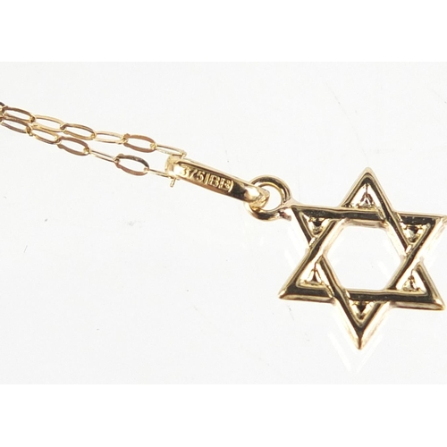 2401 - 9ct gold Star of David pendant on a 9ct gold necklace, the pendant 1.6cm high, total 0.5g