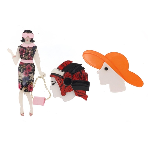 2302 - Three Art Deco design brooches comprising a female with a handbag, female wearing a hat and an India... 