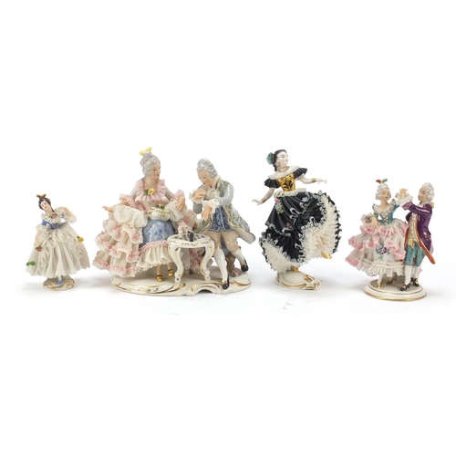 484 - Dresden, four German porcelain lace figurines including a group of a couple playing chess, the large... 