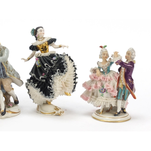 484 - Dresden, four German porcelain lace figurines including a group of a couple playing chess, the large... 