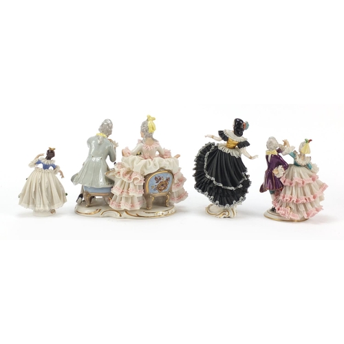 484 - Dresden, four German porcelain lace figurines including a group of a couple playing chess, the large... 