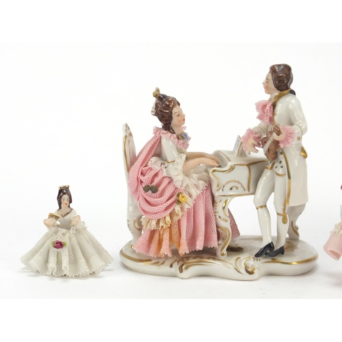 483 - Dresden, three German porcelain lace figurines including a group of two lovers, the largest 18cm wid... 