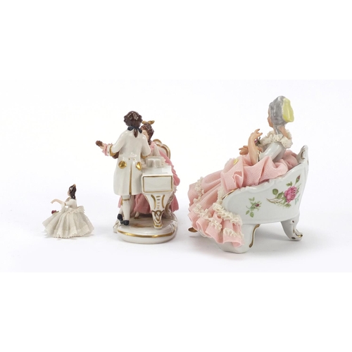 483 - Dresden, three German porcelain lace figurines including a group of two lovers, the largest 18cm wid... 