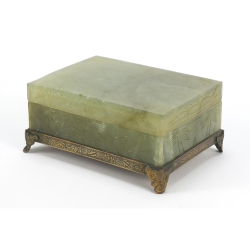 471 - Chinese green jade box and cover carved with flowers on bronzed base, 6cm H x 13cm W x 10cm D