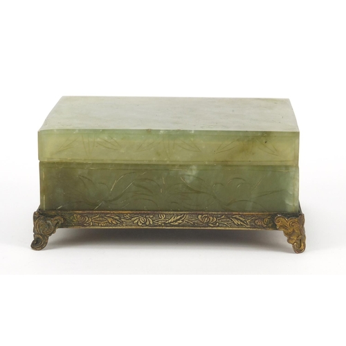 471 - Chinese green jade box and cover carved with flowers on bronzed base, 6cm H x 13cm W x 10cm D