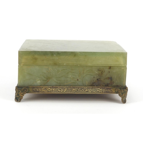 471 - Chinese green jade box and cover carved with flowers on bronzed base, 6cm H x 13cm W x 10cm D