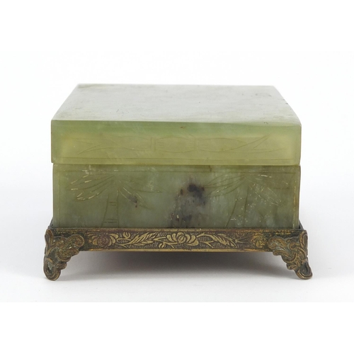 471 - Chinese green jade box and cover carved with flowers on bronzed base, 6cm H x 13cm W x 10cm D