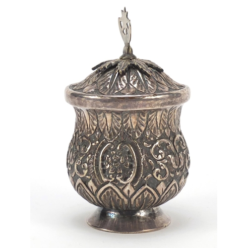 3081 - Persian silver coloured metal baluster cup with hinged lid embossed with flowers and foliage, 13cm h... 