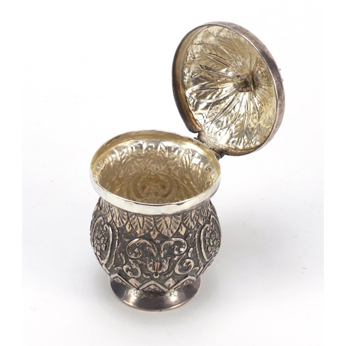 3081 - Persian silver coloured metal baluster cup with hinged lid embossed with flowers and foliage, 13cm h... 