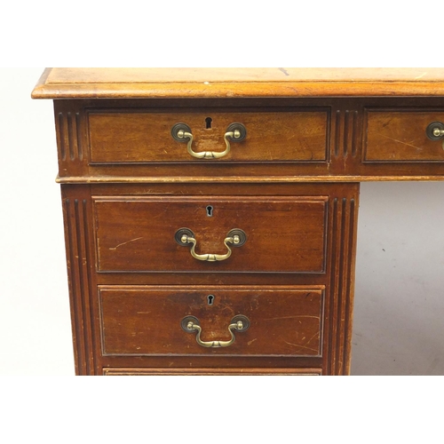 1499 - Mahogany twin pedestal desk fitted with a series of drawers, 74cm H x 152cm W x 107cm D