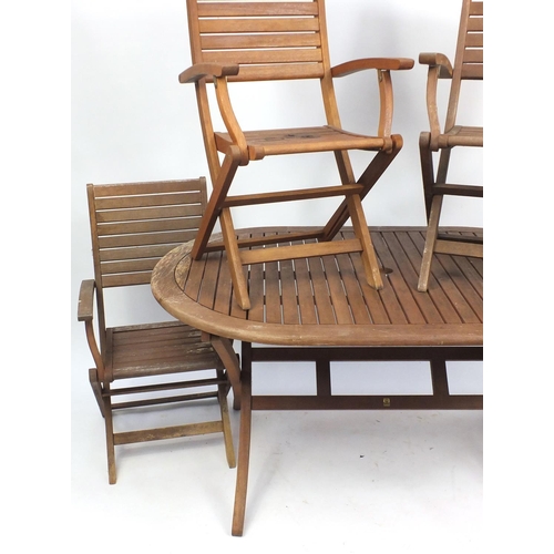 1593 - Teak folding garden table and four chairs, the table 76cm H x 147cm W x 91 D, the chairs each 94cm H
