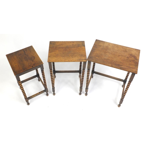 1534A - Nest of three oak occasional tables with bobbin turned legs, the largest 56cm H x 42cm W x 30cm D