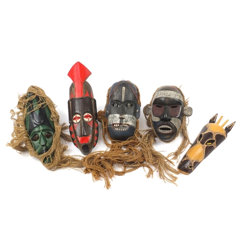 3772 - Six hand painted African carved wood face masks, the largest 46cm high