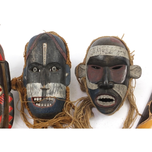 3772 - Six hand painted African carved wood face masks, the largest 46cm high