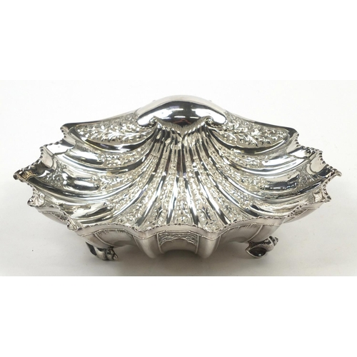 3031 - Atkin Brothers, large Victorian silver shell shaped bowl embossed with flowers and raised on three s... 