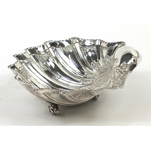 3031 - Atkin Brothers, large Victorian silver shell shaped bowl embossed with flowers and raised on three s... 