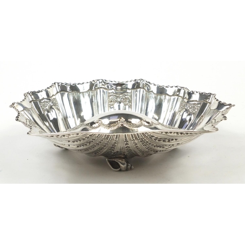 3031 - Atkin Brothers, large Victorian silver shell shaped bowl embossed with flowers and raised on three s... 