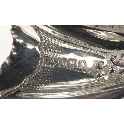 3031 - Atkin Brothers, large Victorian silver shell shaped bowl embossed with flowers and raised on three s... 