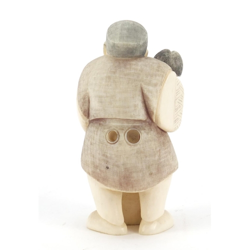 473 - Japanese carved ivory netsuke of a man holding a child, character marks to the base, 6.5cm high