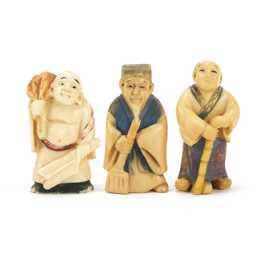 474 - Three Japanese part stained carved ivory netsukes of elders, character marks to the bases, the large... 