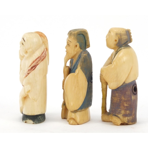 474 - Three Japanese part stained carved ivory netsukes of elders, character marks to the bases, the large... 