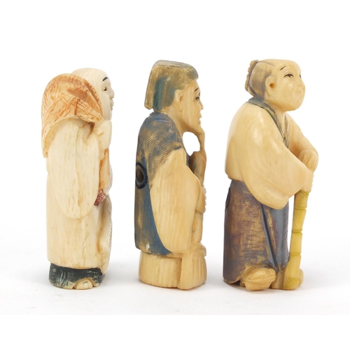 474 - Three Japanese part stained carved ivory netsukes of elders, character marks to the bases, the large... 