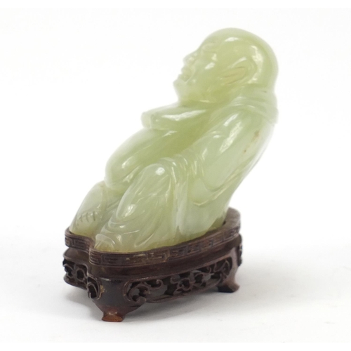 470 - Chinese carved green jade Buddha raised on carved hardwood stand, 11.5cm wide