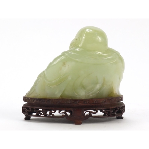 470 - Chinese carved green jade Buddha raised on carved hardwood stand, 11.5cm wide