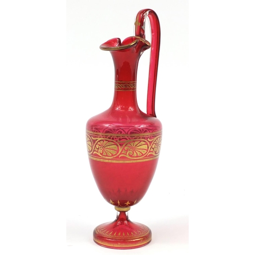 138 - 19th century cranberry glass encaustic ewer with gilded decoration, 37cm high
