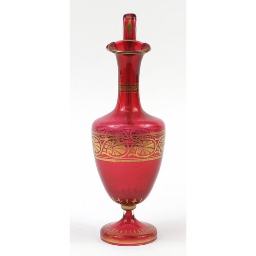 138 - 19th century cranberry glass encaustic ewer with gilded decoration, 37cm high