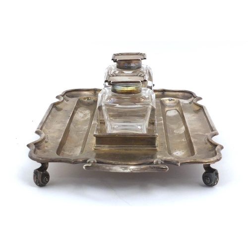 3059 - Thomas Bradbury & Sons, Edward VII silver desk stand  with a pair of heavy cut glass inkwells, raise... 